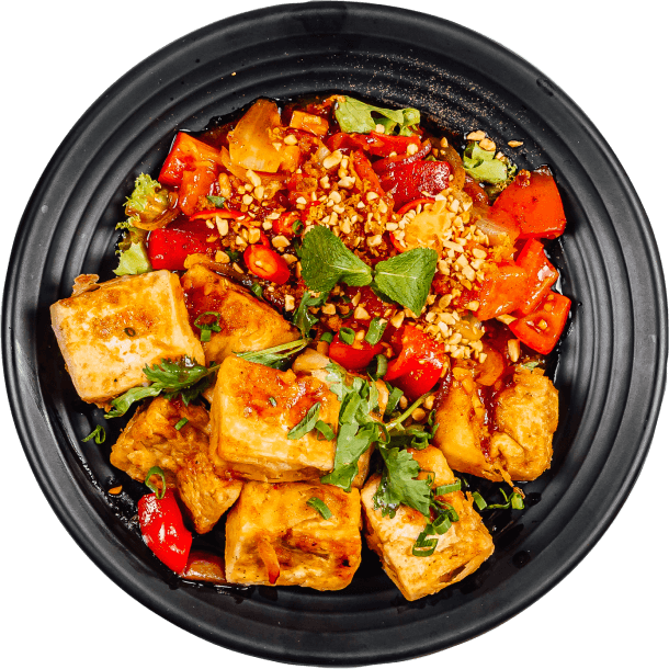 Hero Image, A black dish filled with a colorful assortment of fresh vegetables and bread.